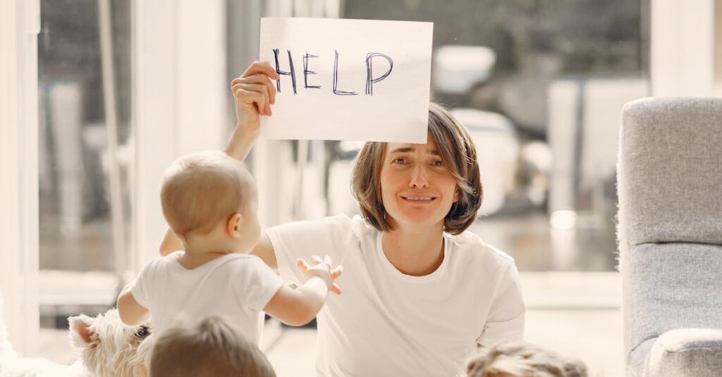 A mother holds a 'HELP' sign while sitting with her children and a dog in a sunlit living room.