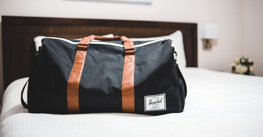 Contemporary baggage bag with inscription on white bed cover in light hotel room