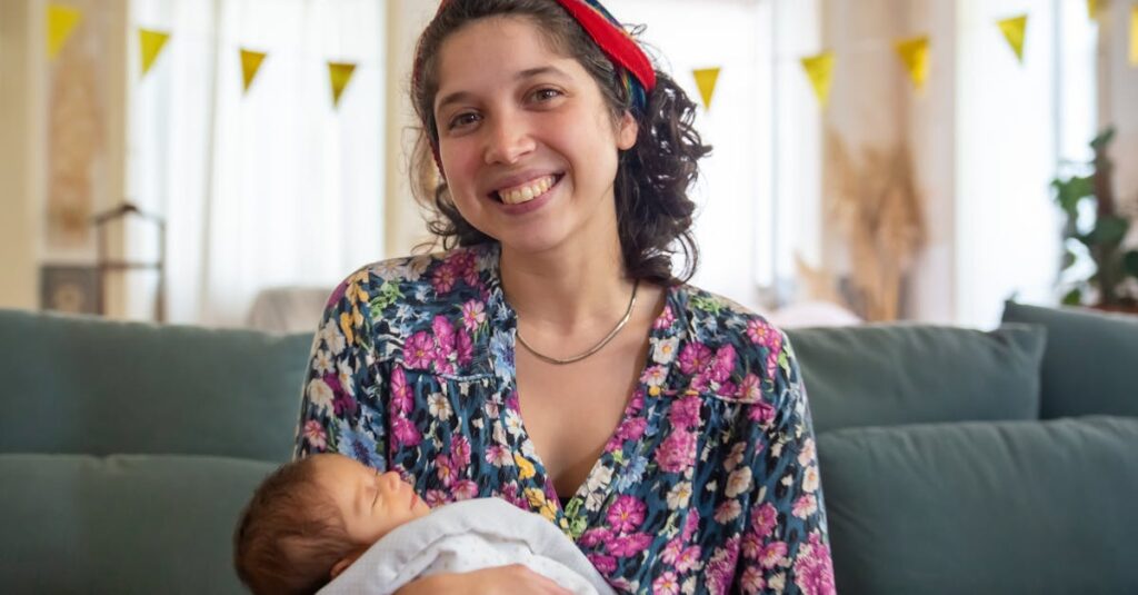 A joyful mother holding her newborn baby, wrapped in a soft blanket, at home in Portugal.