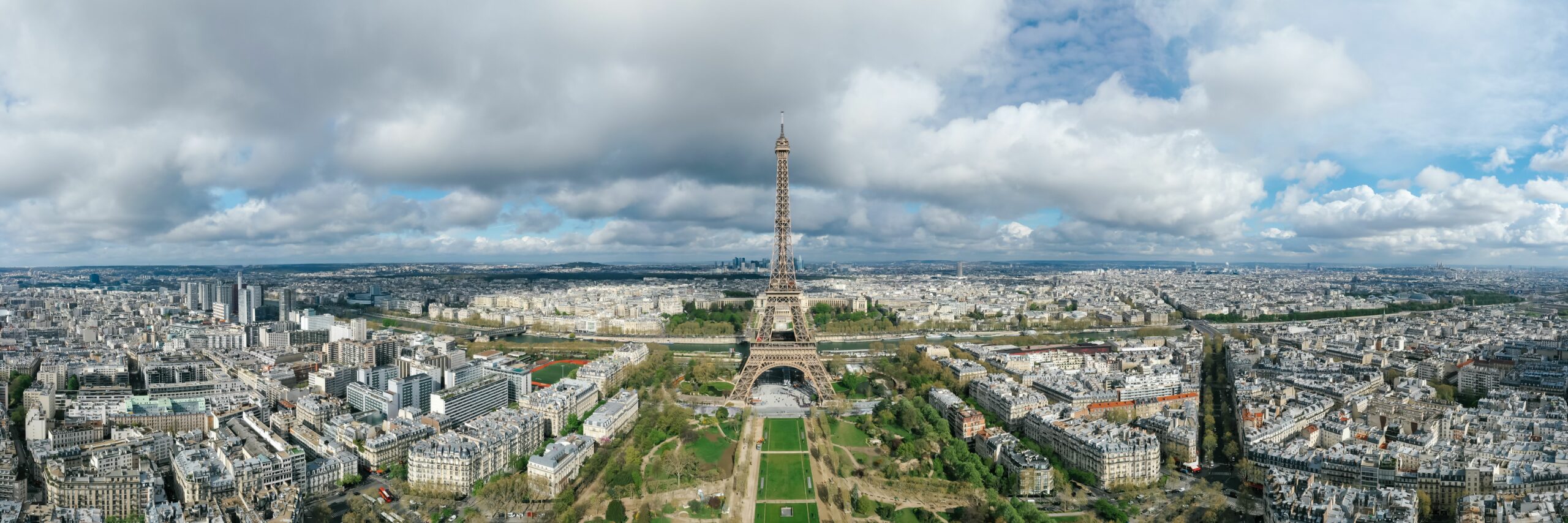 Stunning aerial view of the Eiffel Tower in Paris, capturing the city skyline on a cloudy day.